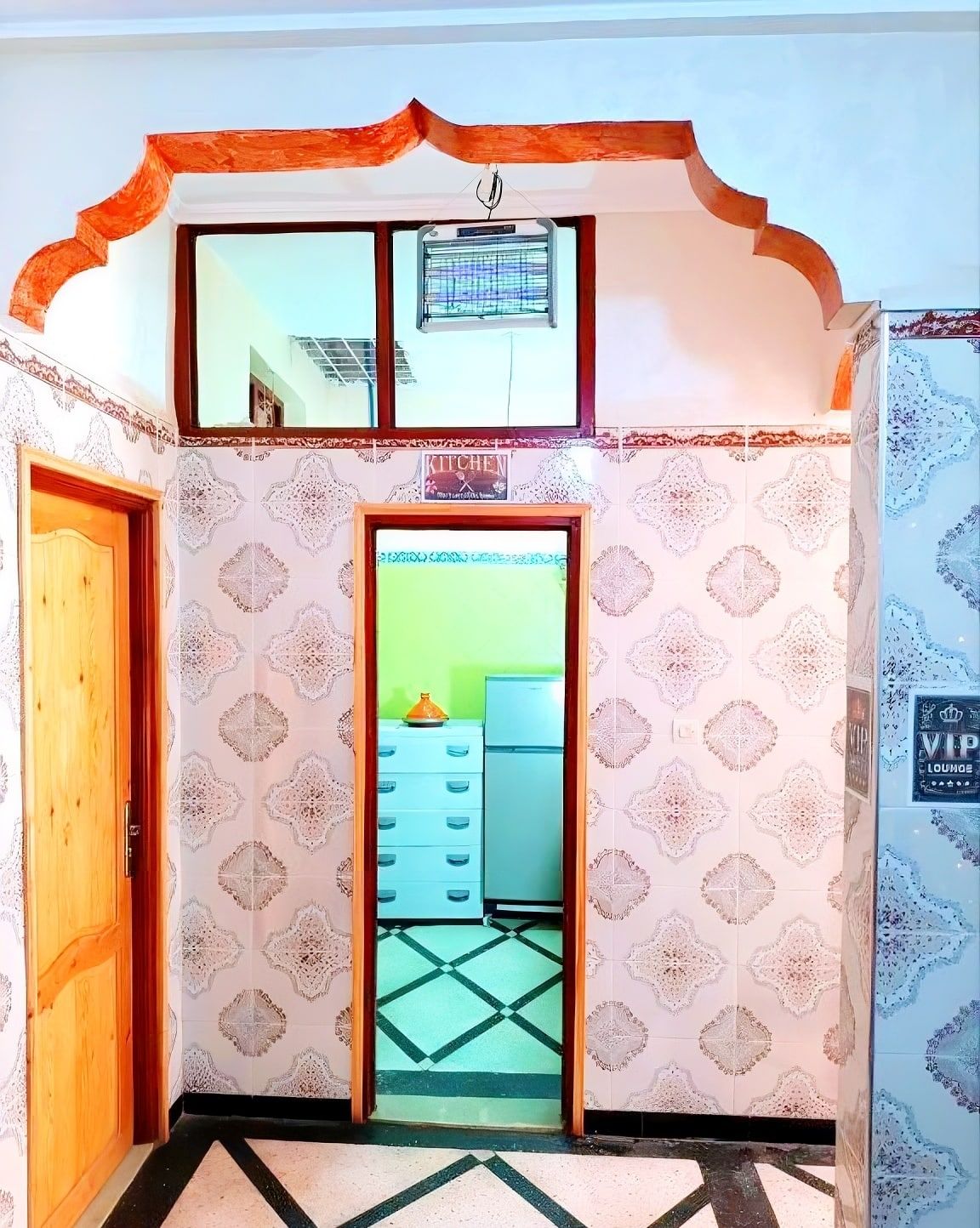 The doorway through to the shared kitchen at Aziz House